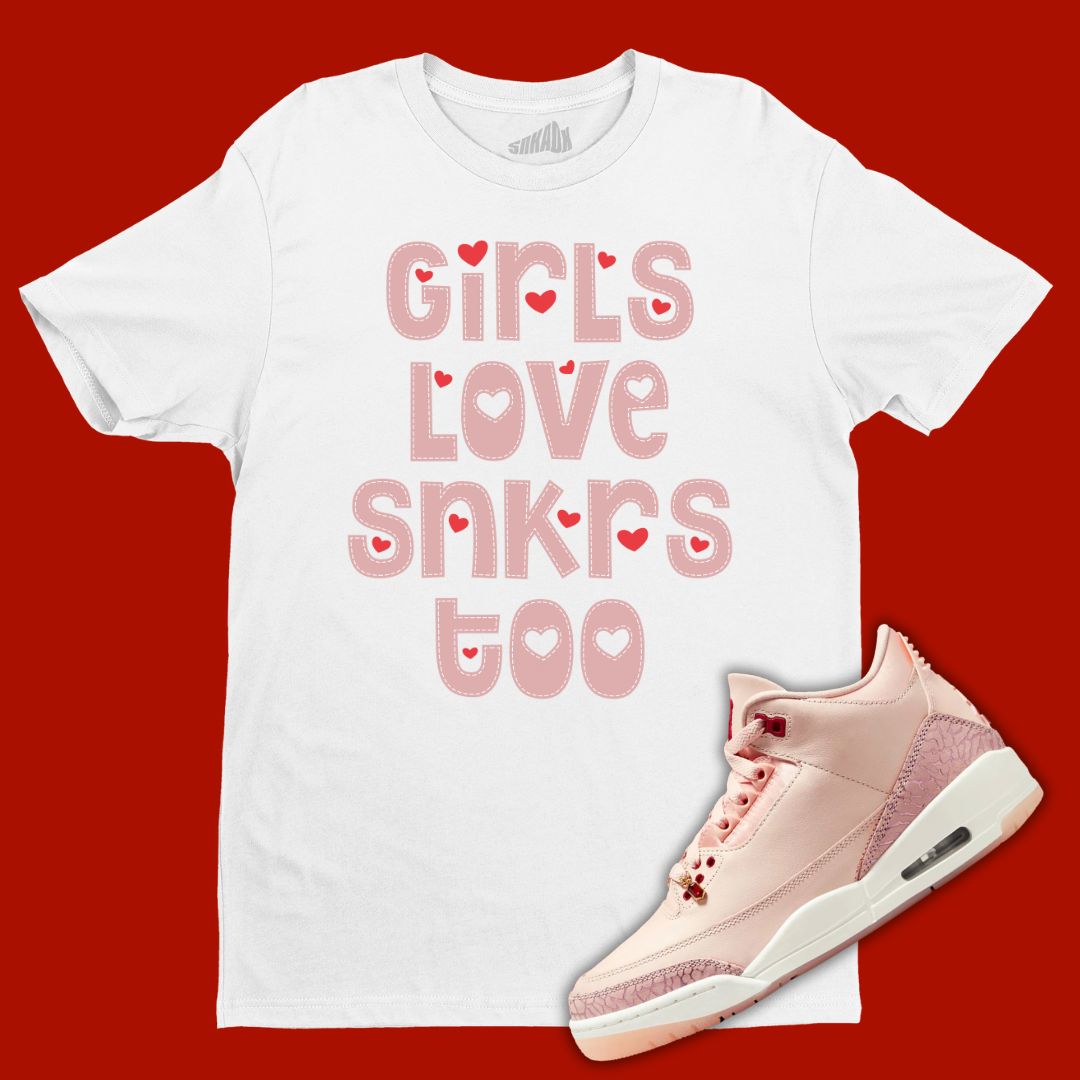 White 'Girls Love Sneakers Too' t-shirt designed to match the Air Jordan 3 Valentine's Day 2025, featuring bold typography and sneaker-inspired graphics.