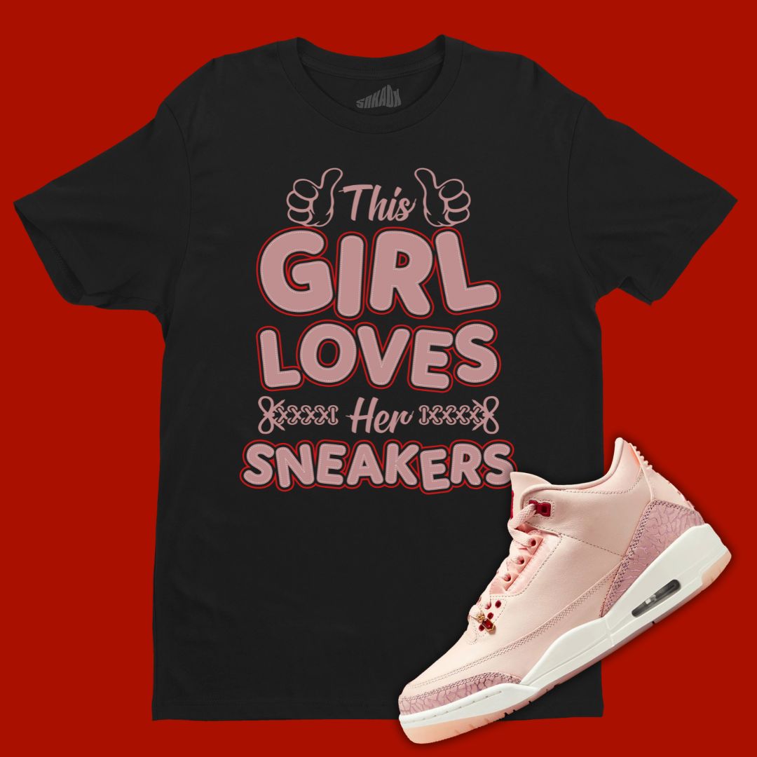 Black 'This Girl Loves Her Sneakers' t-shirt designed to match the Air Jordan 3 Valentine's Day 2025, featuring bold typography and sneaker-inspired graphics.