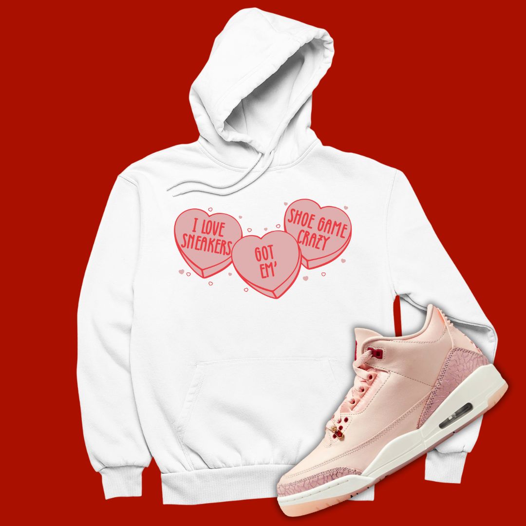 White 'Candy Hearts' pullover hoodie designed to match the Air Jordan 3 Valentine's Day 2025, featuring bold typography and sneaker-inspired graphics.